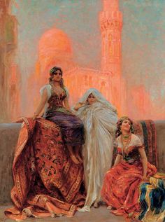 two women sitting on a ledge in front of a building, one wearing a veil