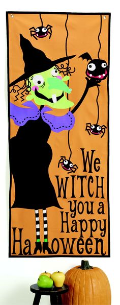 a halloween banner with a witch holding a broom and pumpkins in front of it