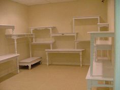 a room filled with white shelves next to each other