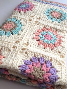 a crocheted blanket sitting on top of a table