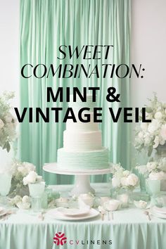 a wedding cake sitting on top of a table next to white flowers and greenery