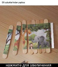 four toothpicks with pictures of animals and giraffes on them sitting on a table