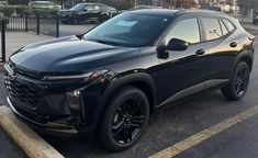 a black suv is parked in a parking lot