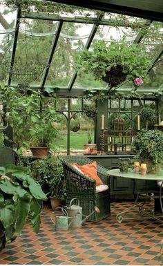 an outdoor dining area with potted plants in the center and tiled flooring on the other side