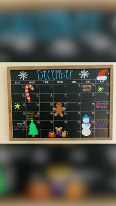 a calendar hanging on the wall with christmas decorations