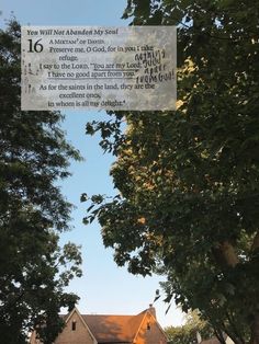 a house with a sign hanging from it's side