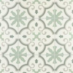 a green and white tile pattern with leaves on the bottom, in an ornate design