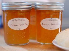 two jars filled with honey sitting on top of a table