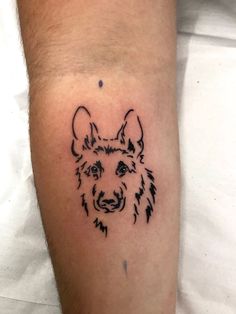 a dog's head is shown on the left arm, and it appears to be in black ink