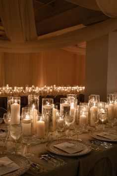 a long table is set with candles and place settings