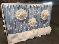 a blue and white backdrop with snowflakes on it in an office cubicle