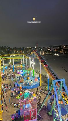 an amusement park at night with people on the rides