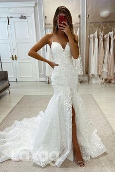 a woman is taking a selfie in her wedding dress while standing in front of a mirror