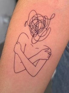 a woman's arm with a tattoo on it that has lines in the shape of a heart