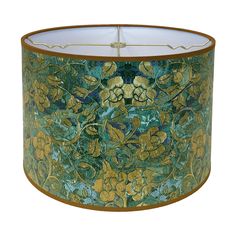 a green and gold lamp shade with flowers on it