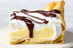 a piece of pie with whipped cream and chocolate sauce