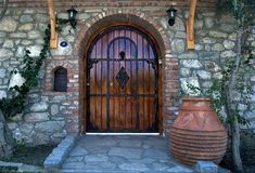 an entrance to a stone building with a wooden door