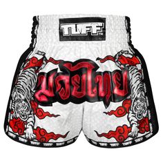 a white and black boxing shorts with red lettering on the side, featuring tiger designs