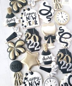 decorated cookies with black and gold decorations on them for new year's eve celebration