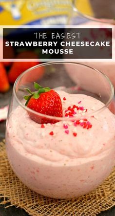 strawberry cheesecake mousse in a glass bowl with strawberries on the side