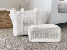 three personalized white towels sitting on the floor