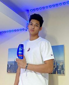 a young man holding a hair dryer in his hand