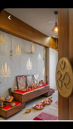 the interior of a temple with decorations on the wall and wooden pillars in front of it