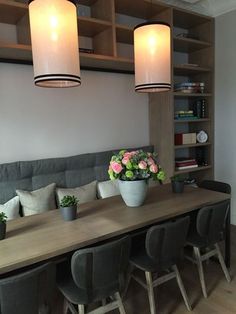 a long table with chairs and flowers on it