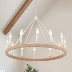 a chandelier with lights hanging from it's sides in a living room