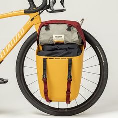 a yellow bicycle with a bag on the back