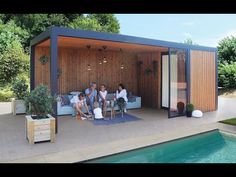 three people sitting on couches in front of a swimming pool with a covered area