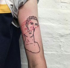 a man's arm with a tattoo on it that has a drawing of him