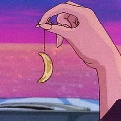 a cartoon hand holding a half - eaten banana in front of a purple and blue sky