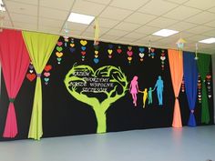 an office decorated with colorful drapes, curtains and art work on the wall for people to see