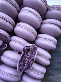 purple macaroons are stacked on top of each other