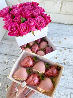 pink roses and chocolate covered strawberries in a white box with gold trimmings