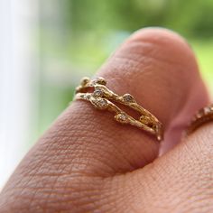 "A solid 14K gold diamond wedding band dusted with tiny diamonds and sculpted from delicate budded sprigs woven to form a crown serving as an engagement ring.  100% recycled gold Every single ring in my collection is designed, sculpted and produced entirely by hand. I never use computers and I never use \"off-the-shelf\" designs that you see in so many jewelry stores. Each ring begins by casting an actual twig or piece of bark; its natural, imperfectly beautiful texture is imprinted in the gold. Nature-inspired Yellow Gold Wedding Diamond Ring, Dainty Hand Forged Stackable Wedding Rings, Contour Ring, Bark Ring, Ring Crown, Nature Engagement Ring, Contour Wedding Band, Nature Inspired Engagement Ring, Matching Wedding Rings