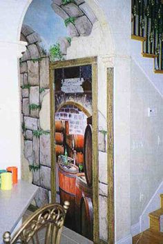 an open door leading to a wine cellar with barrels painted on the wall and stairs