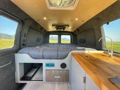 the interior of a camper with a bed and kitchenette in it's center