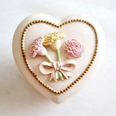 a heart shaped box with flowers in it