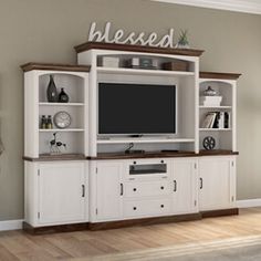 a white entertainment center with built in shelves