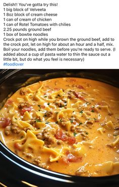 a crock pot filled with pasta, meat and cheese on top of broth