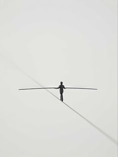 a man standing on top of a tightrope