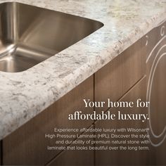 a kitchen counter top with a sink in the middle and an advertisement for luxury marble