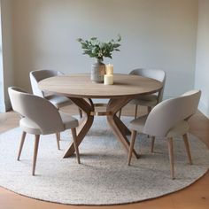 a round wooden table with four chairs around it