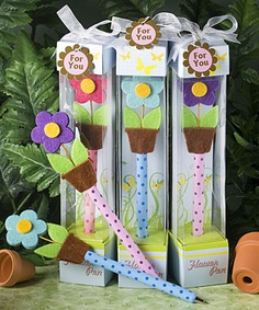 three flower power pens with flowers in them