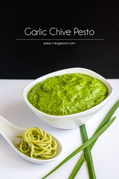 garlic chive pesto in a white bowl next to green noodles