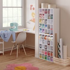 a child's room with a desk, chair and bookcase filled with craft supplies