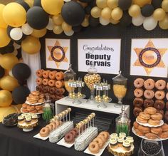 a table topped with lots of donuts and desserts