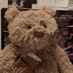 a brown teddy bear sitting on top of a table